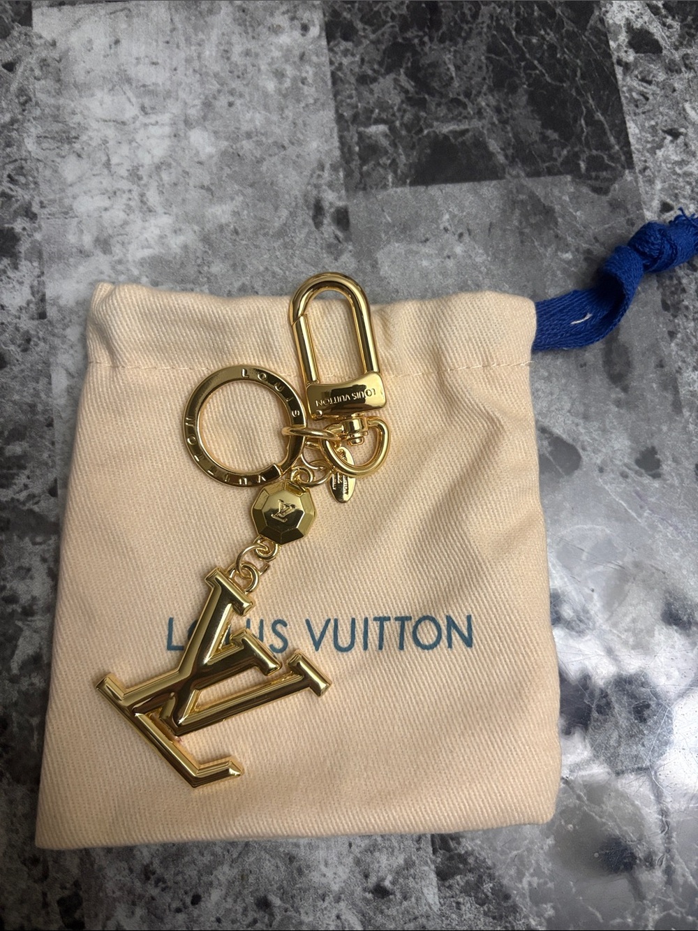 Louis Vuitton gold monogram bag charm